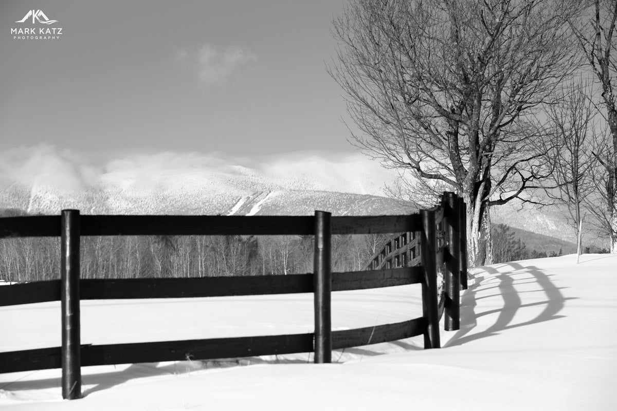 Country fence curving around snowy bend, minimalist winter landscape fine art photography print.
