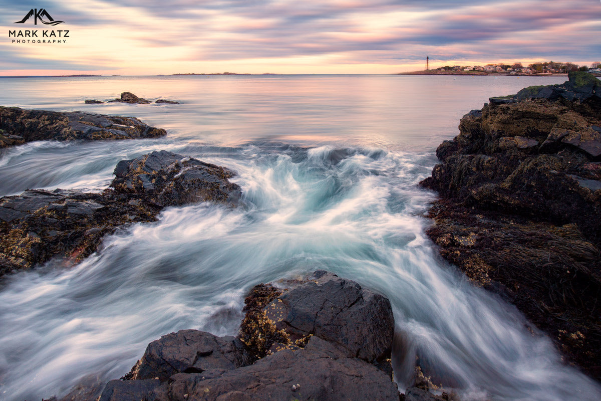 Ocean waves crashing on rocks, dramatic seascape long exposure photograph for coastal decor.