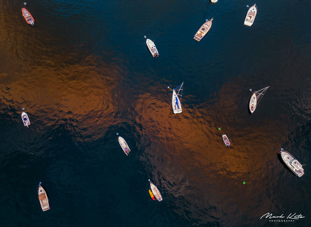 Ocean surface glimmering with golden reflections, atmospheric maritime fine art photography for wall decor.