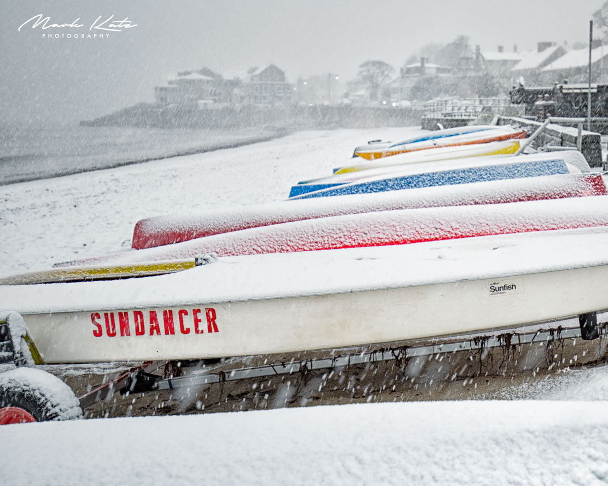 Row of vivid colorful kayaks creating abstract coastal composition, lively fine art photography print.