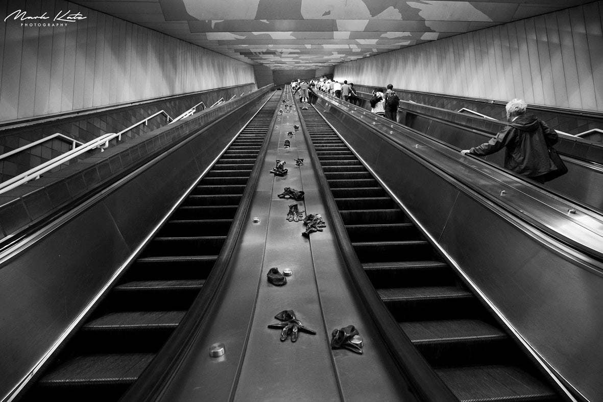 Black and white industrial photo of workers gloves hanging on lines, gritty urban fine art photography.
