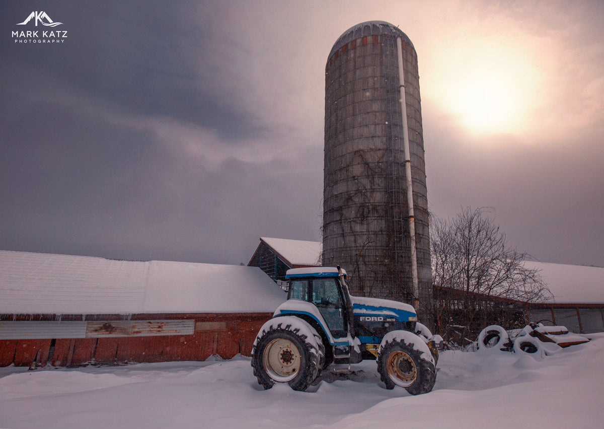 Rural farmland glowing under a soft winter sunrise, fine art photography for rustic interiors.
