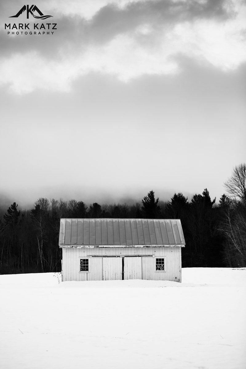 White farmhouse glowing under soft winter skies, fine art photography evoking peace.