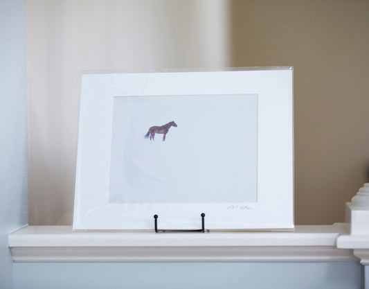 Matted artwork of a horse in the backcountry of Vermont on a snowy day.