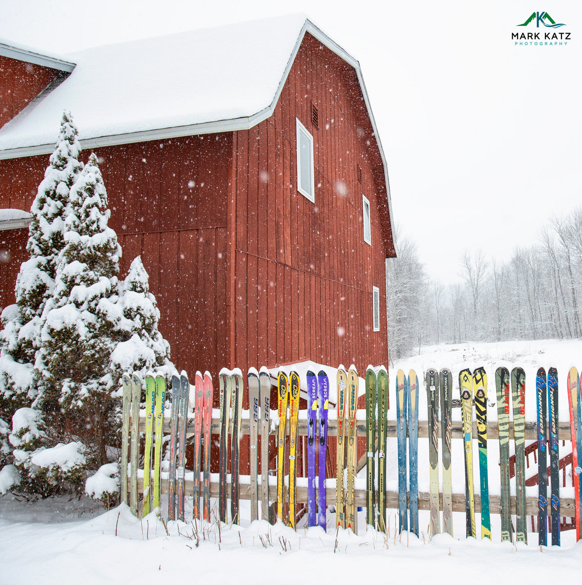 Red Vermont barn amidst snowy hills, nostalgic fine art winter photography evoking skiing adventures.