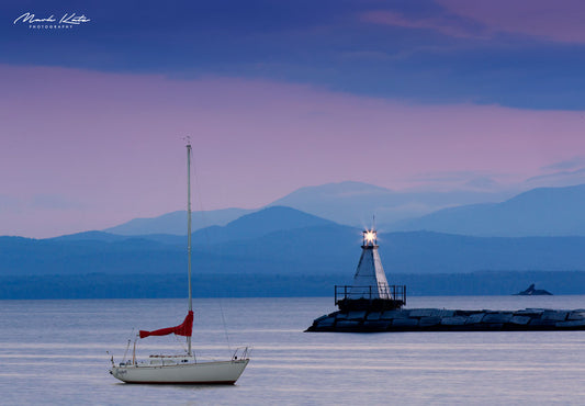 Elegant sailboat crossing Lake Champlain under sunset skies, serene nautical fine art wall art.