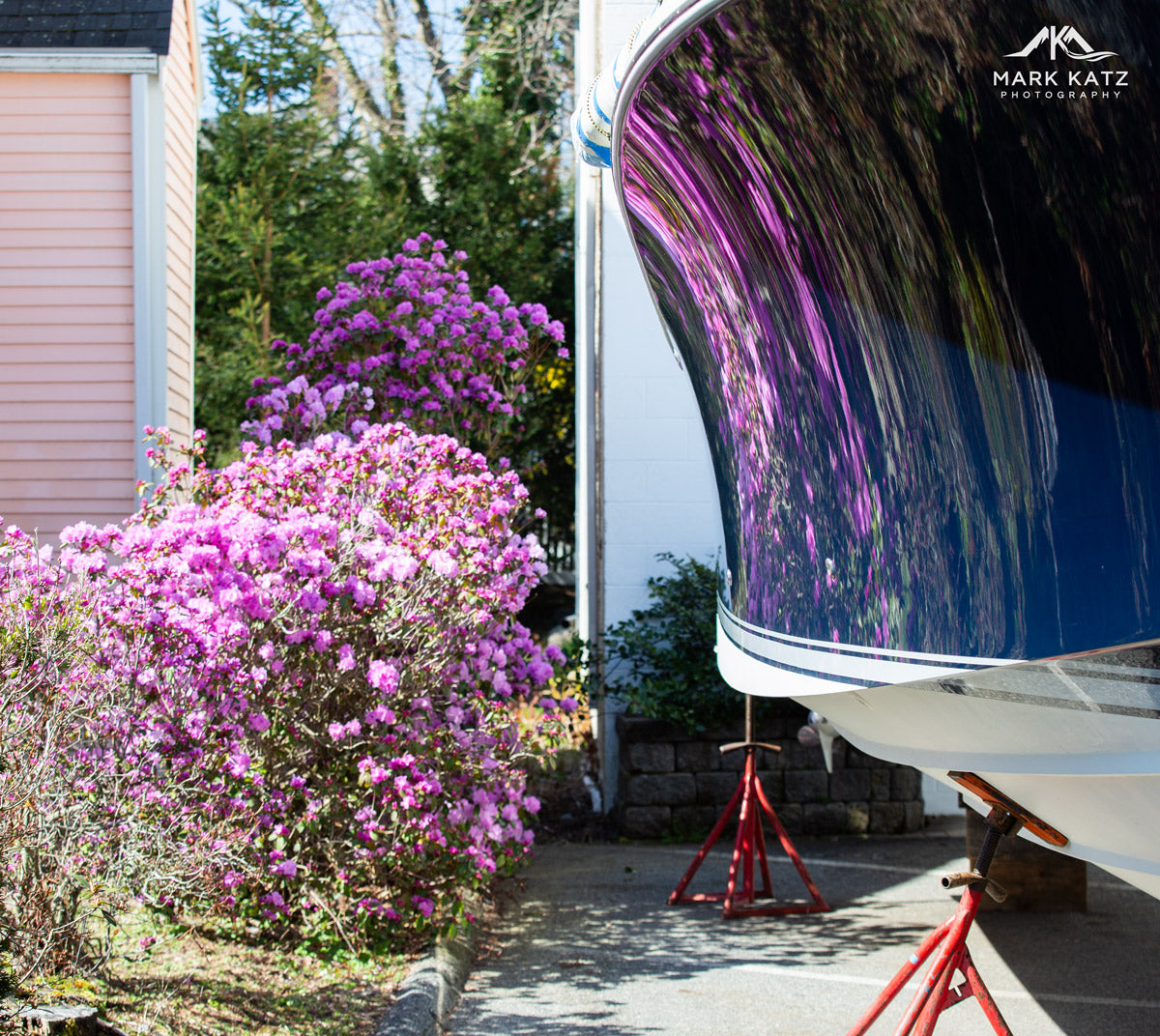 Spring flowers reflected off of boat- coastal fine art photography by Mark Katz.