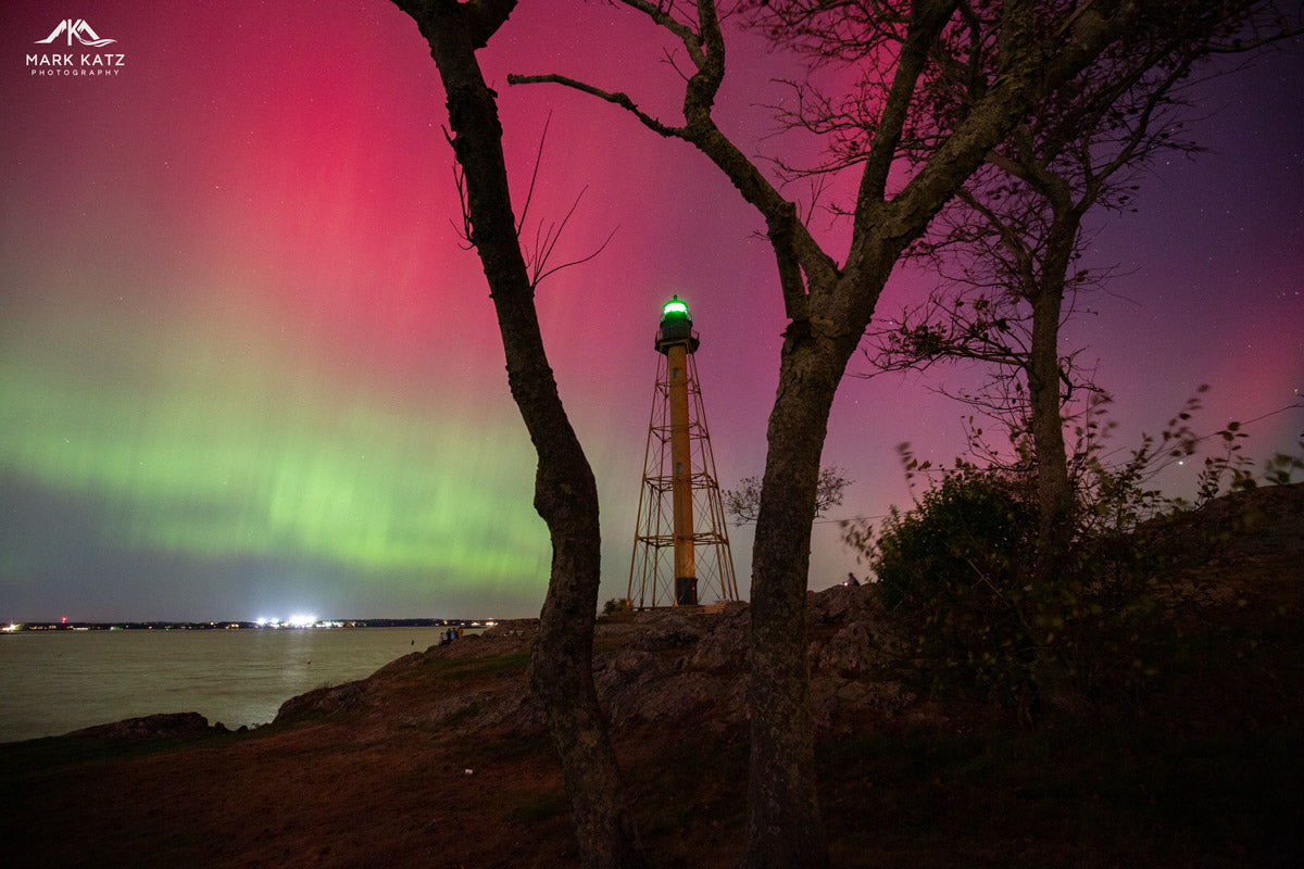 Marblehead Light between trees with a vivid aurora overhead; coastal wall decor