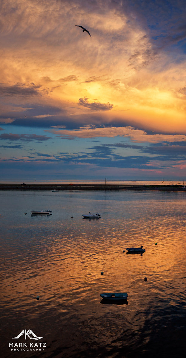 Fiery sunrise over tranquil ocean waters, perfect balance of calm and chaos in seascape photography.