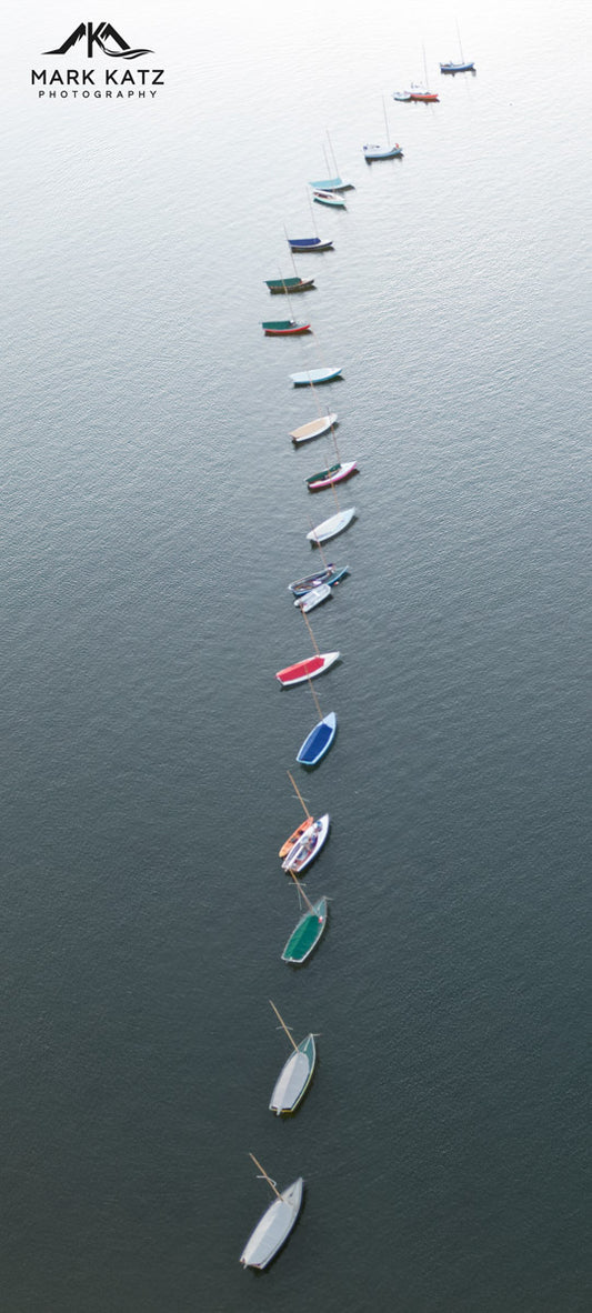 Aerial view of Town Class sailboats lined on blue water, classic maritime fine art photography.