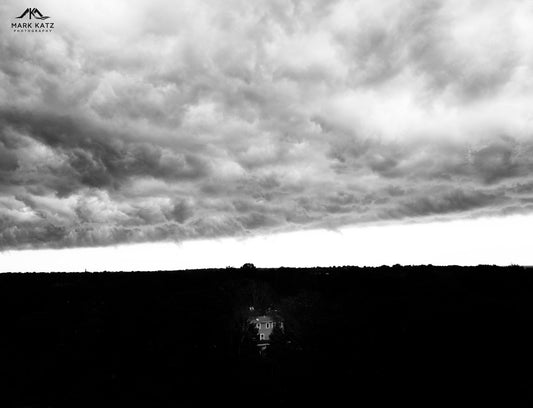 Minimalist black and white photography depicting a hidden house with sharp contrast.