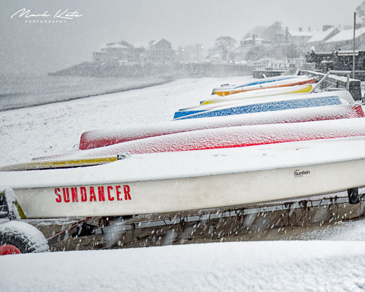 Row of vivid colorful kayaks creating abstract coastal composition, lively fine art photography print.