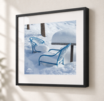 Blue Chairs Beneath Snow in Gallery Black frame with white archival mat