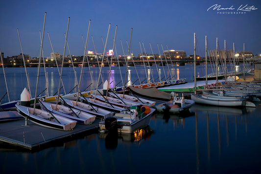 Boats lined up at dock preparing for launch, classic nautical fine art photography perfect for coastal homes.