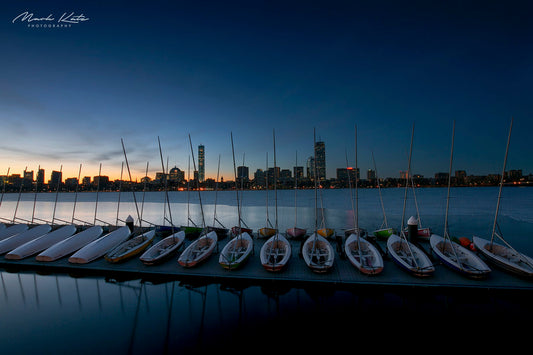 Sailboats lined up neatly in harbor, crisp nautical lineup fine art photography perfect for coastal spaces.