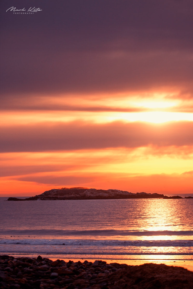 Brilliant orange sunrise behind Ram Island lighthouse, vibrant nautical fine art seascape photography.