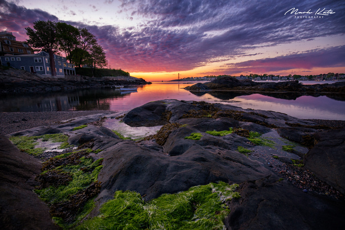 Brilliant sunrise casting golden glow over gentle seaside waves, coastal sunrise fine art photography piece.