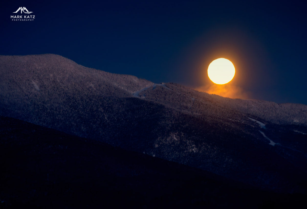 Full moon illuminating snowy arctic landscape, dramatic night fine art photography for wall art.