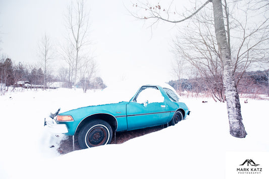 Classic vintage car parked in snowy landscape, artistic winter photography wall art.