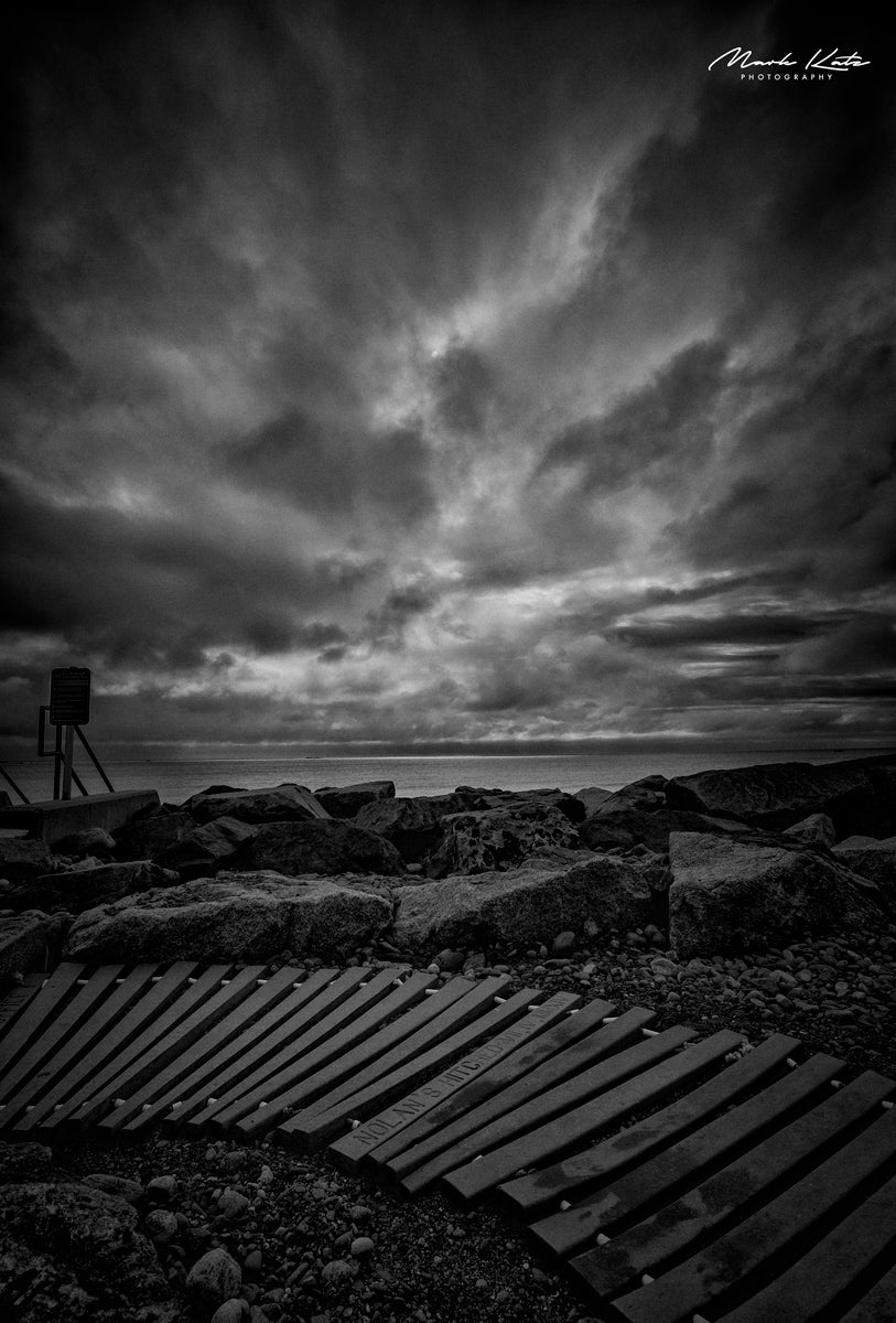 Beach access, evoking roller coaster motion in striking black and white seascape fine art photo.