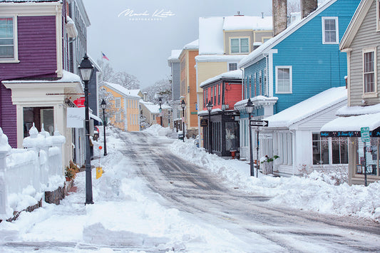 Snowy path between historic houses in Marblehead, conveying winter solitude in minimalist fine art photo.
