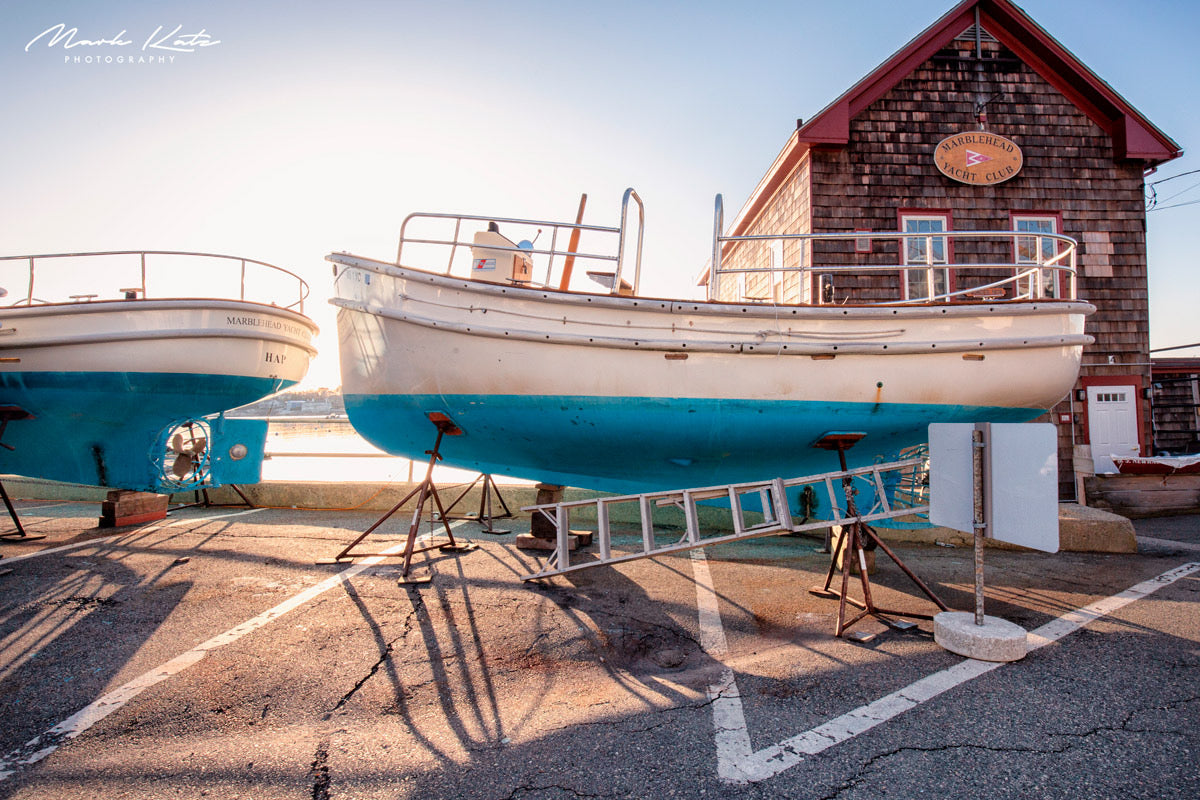 Bright sun splashing onto sailboats and harbor water, vibrant nautical fine art photography.
