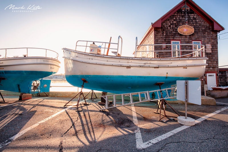 Bright sun splashing onto sailboats and harbor water, vibrant nautical fine art photography.