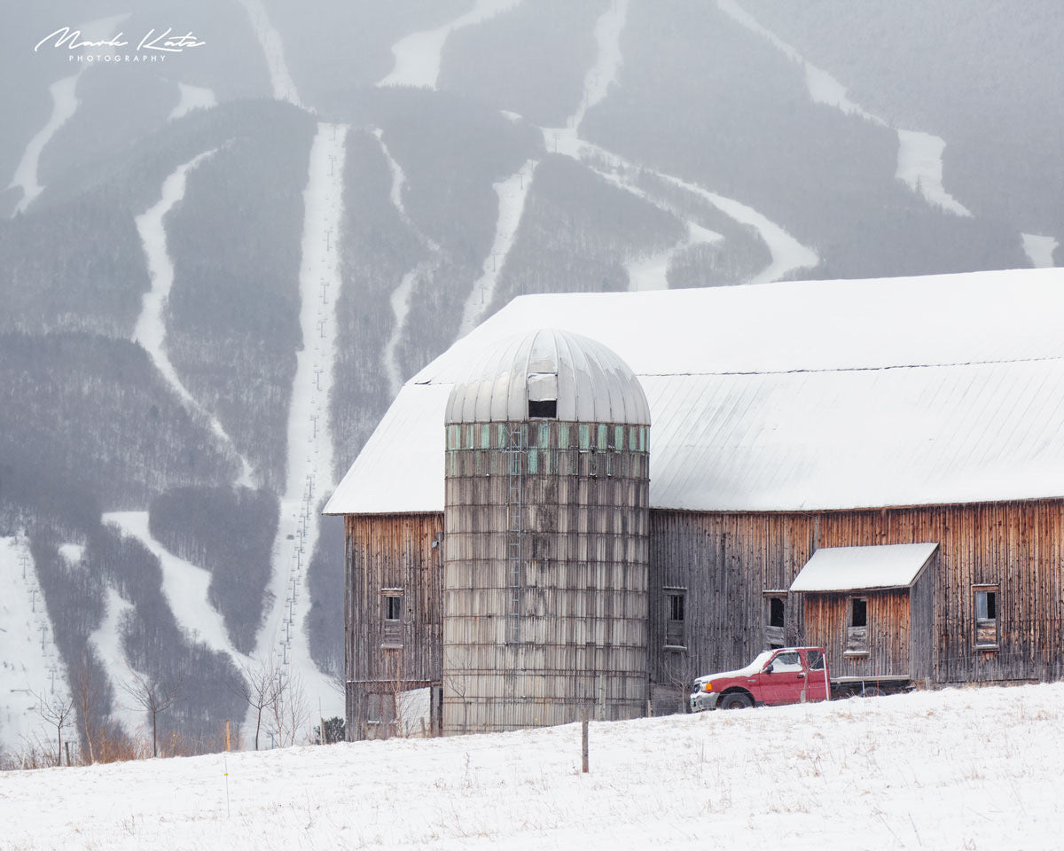Barn juxtaposed with ski terrain, capturing authentic Vermont lifestyles in fine art photography.