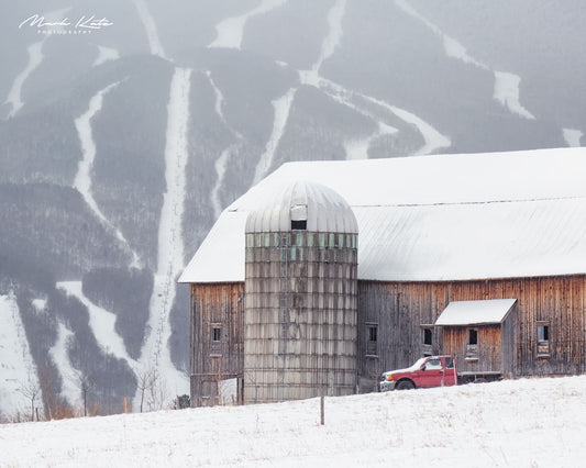 Barn juxtaposed with ski terrain, capturing authentic Vermont lifestyles in fine art photography.