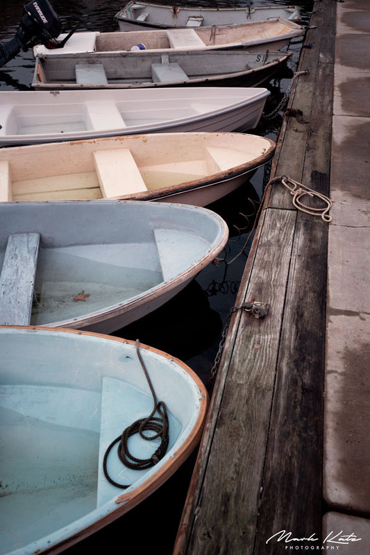 Sailboats lined up neatly in harbor, crisp nautical lineup fine art photography perfect for coastal spaces.