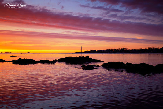 Ocean horizon glowing under fiery painted sky, vibrant sunset seascape fine art photography.