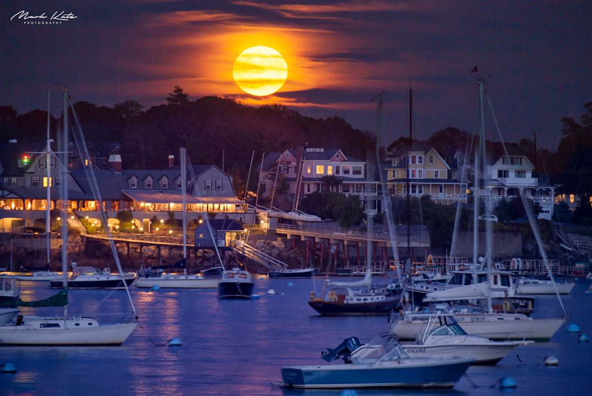 Large hunter’s moon glowing over harbor, dramatic coastal fine art photography perfect for nautical decor.