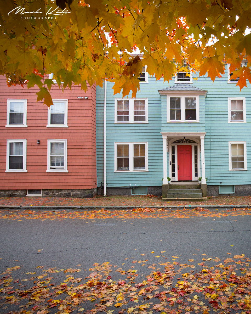 Historic Marblehead houses surrounded by vibrant autumn foliage, picturesque New England fall photography.