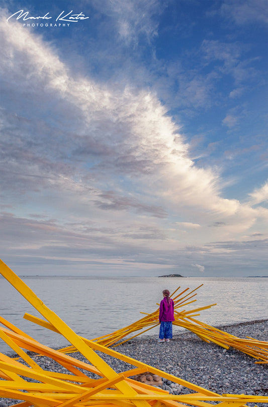 Pink sunset glow embedded in ocean horizon, art installation by Jeremy Barnett