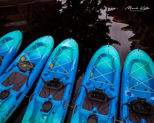 Bright kayaks arranged in vibrant pattern, colorful fine art coastal photography perfect for modern interiors.