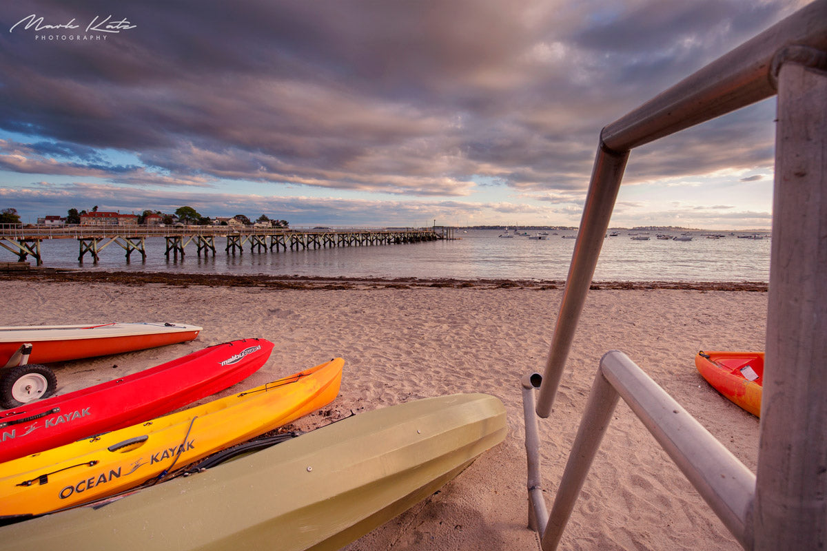 Vibrant kayaks capturing a lively summer beach day, fun fine art coastal photography.